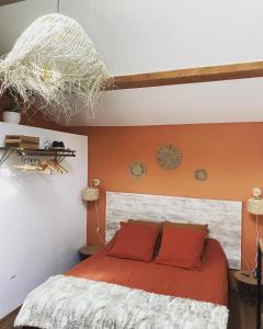 贝沙克和凯洛Villa Belharra的一间卧室配有一张橙色墙壁的床