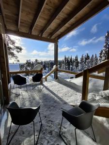 索特Pikkuhukka的庭院配有椅子,享有雪覆盖的树木美景