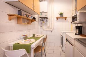 布达佩斯Central Lovely rooms的一个带绿色桌椅的小厨房