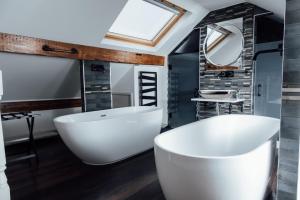 绍斯波特Arthur's Bar & Accommodation的浴室配有大型白色浴缸和水槽