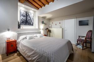 佛罗伦萨YiD luxury & Design penthouse L5的卧室配有白色的床和冰箱。