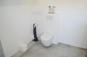 吕贝克Pension Lübeck的白色墙壁上带卫生间的浴室