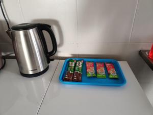普特拉贾亚Jannah Homestay Seruling的咖啡壶旁柜台上的带巧克力的托盘