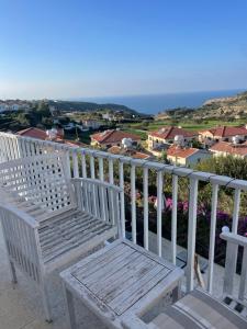 皮斯索里Pissouri Villa Miramar的白色长凳,位于一个美景阳台