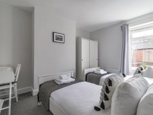 ChoppingtonEast House - Inviting 3 Bed Stakeford的酒店客房设有两张床和窗户。
