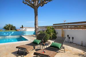 拉克鲁斯Casa Paraíso的一个带两把椅子的庭院和一个游泳池