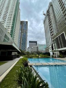 宿务Cozy on the 28th! IT Park Cebu City的一座位于高楼城市的游泳池