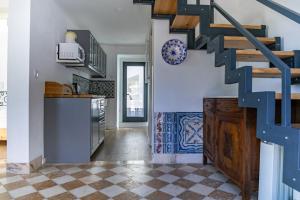 辛特拉Casota - Lusitália Eden的一间设有楼梯和瓷砖地板的厨房