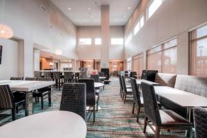 夏洛特Residence Inn by Marriott Charlotte Airport的用餐室设有桌椅和窗户。