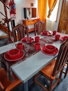 乌斯怀亚Cabaña Ceferino Ushuaia的一张桌子上放着红盘和酒杯
