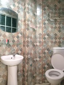 拉布安HOTEL RK CAHAYA的浴室配有卫生间、盥洗盆和淋浴。