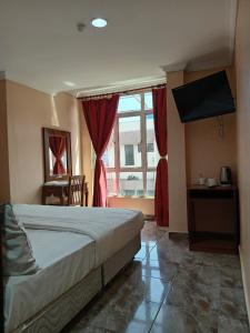 拉布安HOTEL RK CAHAYA的一间卧室设有一张床和一个大窗户