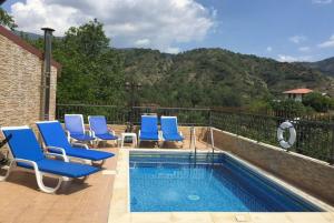 Tris EliesThe Love Holiday House的游泳池旁设有蓝色躺椅