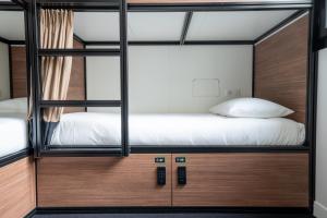 巴黎Beau M Paris的一间卧室配有两张双层床和木制橱柜