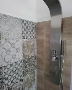 诺瓦拉La Bolgora Guesthouse的浴室的墙壁上设有瓷砖和淋浴。