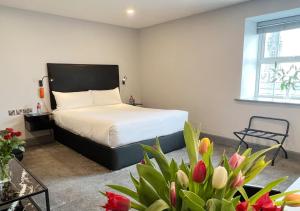 科芙贝拉维斯塔自助式套房酒店的卧室里有一床,鲜花盛开