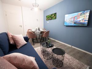 吉森Noble Suite - Living & Work Place的客厅配有蓝色的沙发和桌子
