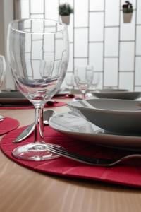 波尔图Júlio de Matos Guest House的红餐巾上的酒杯桌子