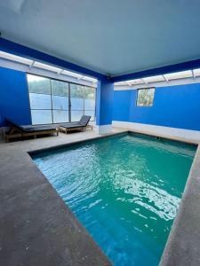 卡拉马Departamento Frente a Espacio Grecia, Calama.的蓝色房间的大型游泳池