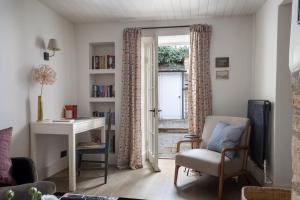 斯托昂泽沃尔德Whitsun Cottage的客厅配有书桌和窗户。