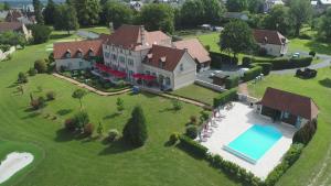 BonnatHôtel et Restaurant Domaine de l'Orangerie的享有带游泳池的大房子的空中景致