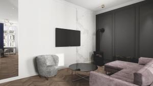 卡托维兹Deco Apartments Mariacka 8的客厅配有沙发、椅子和电视