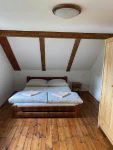 RůžováChata Pepina的一间卧室配有一张铺有木地板的床。