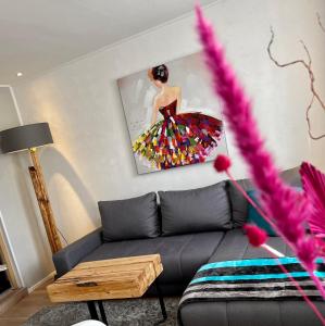 戈斯拉尔Die Altstadt Appartements Caprice的客厅配有沙发和一幅女人画