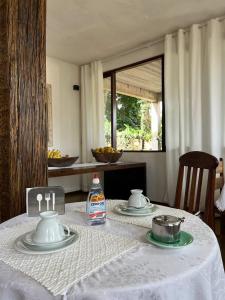 蒂拉登特斯Cama e Café Tiradentes的一张桌子,桌子上配有白色桌布,桌布