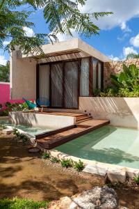 ConkalLa Parcela Cunkal的一座房子,设有一座带木甲板的游泳池