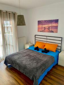 普里诺斯VILLA ARMONIA GUEST HOUSE的一间卧室配有一张带橙色枕头的大床