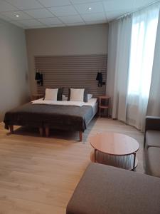 莫斯Moss Hotel & Apartments的一间卧室配有一张床、一张桌子和一张沙发