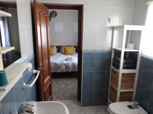 AlmogíaB&B Casa Sarandy的一间带水槽和卫生间的浴室以及一张床