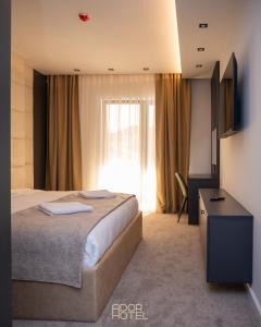 米特罗维察Ador Hotel North Mitrovica的酒店客房设有床和窗户。