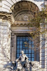 伦敦Town Hall Hotel - Shoreditch的坐在建筑物前的雕像