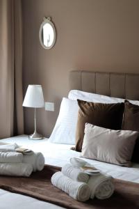 博洛尼亚A Casa Tua的一间卧室配有两张床,并备有折叠毛巾。
