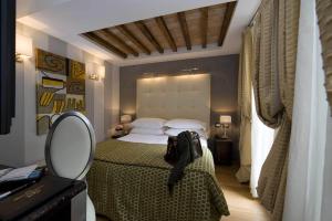 罗马杜卡德阿尔巴酒店的一间卧室配有一张大床和镜子