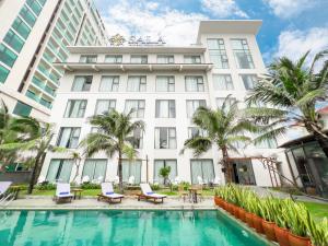 绥和市Sala Tuy Hoa Beach Hotel的大楼前设有游泳池的酒店