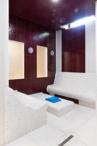 杰尔Golden Ball Club的浴室铺有红色瓷砖,地板上装饰有蓝色物品。