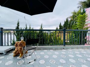 阿普春安Cô Liên Gia Trang的阳台配有桌椅和遮阳伞
