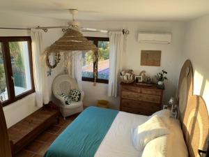 特乌拉达Moraira vue mer et montagne的卧室配有床、椅子和窗户。