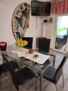 阿瓜杜尔塞Casa Violeta的玻璃桌子和椅子,上面有一碗水果