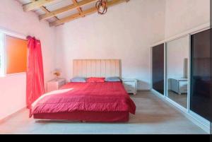 哈拉瓦科阿Sunflower village villa girasoles的一间卧室,卧室内设有一张红色的大床
