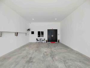 实兆远New Single Storey Homestay @ Sitiawan 3R2B (6-9PAX) _Feb Moment Homestay的一间白色的房间,配有两把椅子和一扇黑色的门