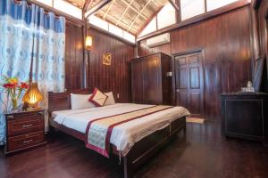 富国洪文度假酒店的一间卧室设有一张床和木墙