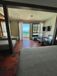 阿拉亚尔-杜卡布Orlanova Hotel的一间卧室配有一张床,享有海景