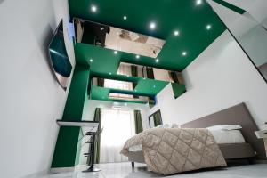 那不勒斯Al Campanile H Napoli Centro, by ClaPa Group的一间绿色和白色的卧室,配有一张床和一个楼梯