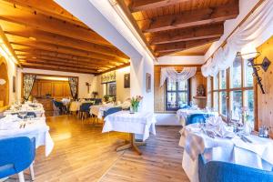劳特尔巴赫凯普欧霍夫酒店的用餐室配有白色的桌子和蓝色的椅子