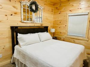 芒廷维尤Knotty Squirrel Cabins的卧室配有木墙内的一张床