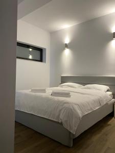 锡盖图马尔马切伊MODERN House的一间卧室配有一张带白色床单的床和一扇窗户。